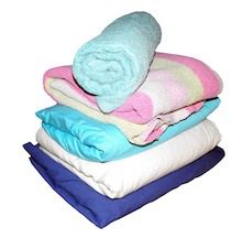 This is a photo of folded linens and towels and is used to illustrate laundry on the energy savings checklist.